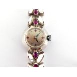 A mid 20th century French 18 carat white gold and ruby cocktail watch, the silvered dial with ruby