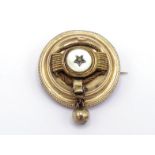 A Victorian gold boss brooch, circa 1870, with a mother of pearl panel to the centre, granulation to