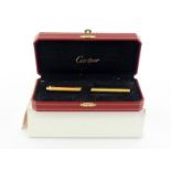 CARTIER, a gold plated fountain pen, with burgundy lacquer clip, fine nib and cartridge filler