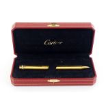CARTIER, Must de Cartier, a gold plated ballpoint pen, with its box, in working condition