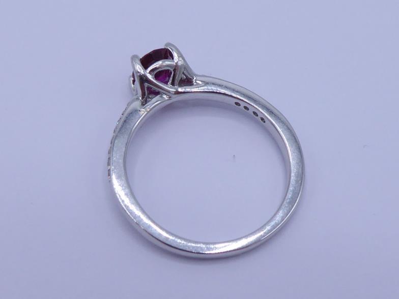 A ruby and diamond ring, the central oval cut stone approx. 0.77 carat (6 x 5 x 3mm), claw set above - Image 2 of 3