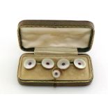 A pair of Edwardian mother of pearl and ruby cufflinks, each link 13mm diameter, mounted in pink