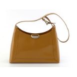 A Sergio Rossi Camel leather handbag with silvertone plaque and buckle to strap. Ferre label inside.