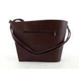 An Italian designer leather handbag, of asymmetric design, 35cm wide CONDITION: good, minimum