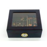 A cigar humidor with view panel and hygrometer containing about 45 small Willem cigars and 13