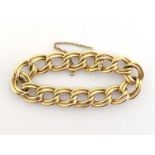A gold bracelet, composed of double curb links, stamped '14k', 18cm long, with safety chain, 39.2gms