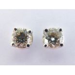 A pair of diamond ear studs, both brilliant cuts totalling approx. 0.61 carat, mounted in white