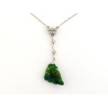 An Art Deco jadeite and diamond pendant, the green jadeite drop carved as a cluster of leaves, the