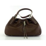 A TODS brown leather handbag with imitation horn details. Labelled inside" TODS, made in Italy".