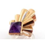 A 1940s gold and amethyst dress ring, the square sugar loaf cut amethyst 9.8 x 9.8 x 6.6mm, rub over