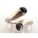Georg Jensen, a silver, onyx and moonstone 'Carnival' ring by Regitze Overgaard, the cross over