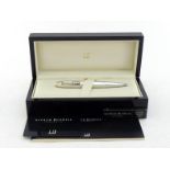 DUNHILL, a faceted silver 'Torpedo' limited edition ballpoint pen with clock, no. 89/350, the signed