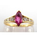 A pink sapphire and diamond ring, the central marquise cut sapphire 8 x 4mm, to channel set