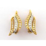 A pair of diamond ear clips, each clip composed of three lines of pave set graduated brilliant and