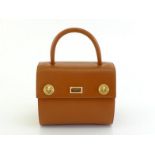 A Gianfranco Ferre tan leather box shape handbag with goldtone hardware. Stamped Ferre No 16282 on