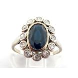 A sapphire and diamond cluster ring, the central oval cut sapphire 9.2 x 6.2 x 4mm (approx. 1.82),