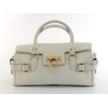 A Salvatore Ferragamo white leather handbag with Gancini closure. Labelled inside ""Salvatore