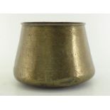 A large Islamic brass communal cooking pot with domed base , inward tapering sides and rolled rim,