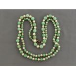 A jadeite and cultured pearl necklace, composed of graduated alternate jadeite beads and white