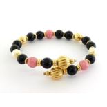 A yellow metal (test 14 carat gold), onyx, cultured pearl and rhodochrosite bead bracelet, wire set,
