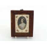 German School, a 19th. century half length oval miniature of a young lady with long ringlets and