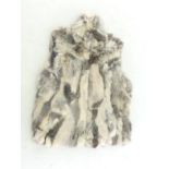 A zip up rabbit fur gilet. Size medium.