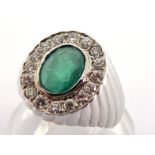 An emerald and diamond cluster signet ring, the central emerald 8 x 6mm, in a surround of of