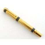 AURORA Italia, a gilt metal limited edition fountain pen, no. 1700, with medium nib and piston