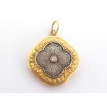 An early 20th century gold and diamond locket, the cushion shaped locket with a central 0.05 carat