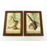 A pair of hand painted ceramic tile wall hangings of game, one a pheasant, the other a rabbit,