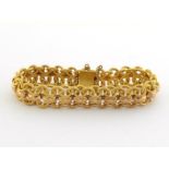 An 18 carat gold bracelet, composed of interlinked textured hoops and faceted bars between, the