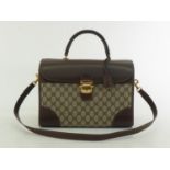 WITHDRAWN A Vintage Gucci monogrammed travel bag with leather accents, striped fabric strap and