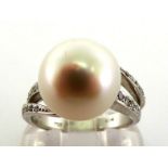 A South Sea cultured pearl and diamond ring, the pearl 12mm diameter, to pave set shoulders,