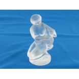 A Lalique figurine of a naked girl holding a young kid, the original paper label to underside. Ht.