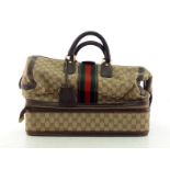 A Vintage Gucci monogrammed Weekender travel bag with leather handles and separate compartment to