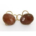 A pair of 18th century goldstone earrings, each faceted oval stone 19mm long, collet set in a yellow