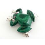 A malachite and ruby brooch, modelled as a frog, with ruby cabochon set eyes, mounted in white metal