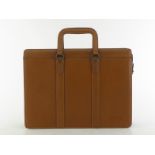 A Gianfranco Ferre gentleman's tan leather briefcase with gunmetal hardware and side closure, no