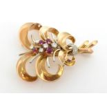 A ruby and diamond spray brooch, the spray centred on a cluster of round brilliants and graduated