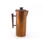 A hand-raised copper coffee pot with bark finish, circa 1970, with teak handle. In very good