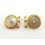 A pair of Edwardian 18 carat gold, mother of pearl and enamel cufflinks, each link centred on a