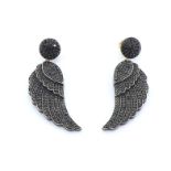 A pair of black diamond earrings, designed as a pair of wings, pave set overall with circular