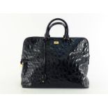 A large Gianfranco Ferre embossed patent leather handbag with goldtone hardware, to include a