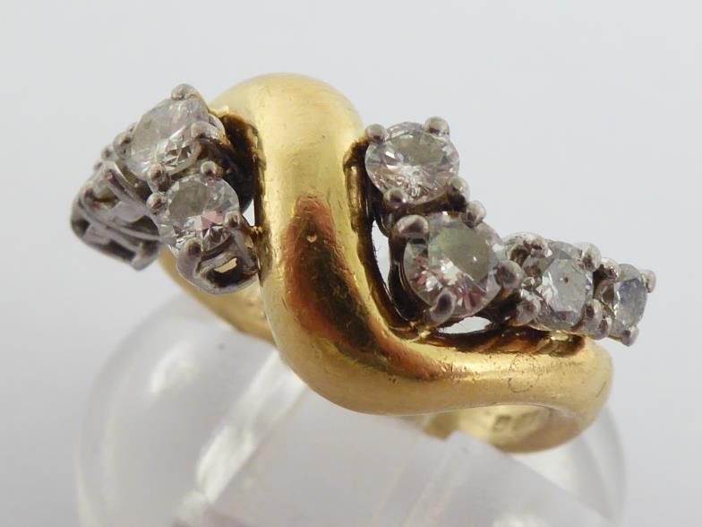 An 18 carat gold and diamond dress ring, the undulating bezel set either side with graduated - Image 3 of 6