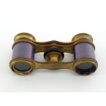 A pair of pocket size opera glasses in matt gilt brass, the body with engine-turned mauve enamel