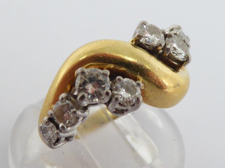 An 18 carat gold and diamond dress ring, the undulating bezel set either side with graduated - Image 2 of 6