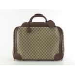 A vintage Gucci monogrammed carry on travel case with leather accents and handles. A nice example,