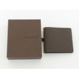 LOUIS VUITTON, a brown leather wallet, in its box CONDITION: as new