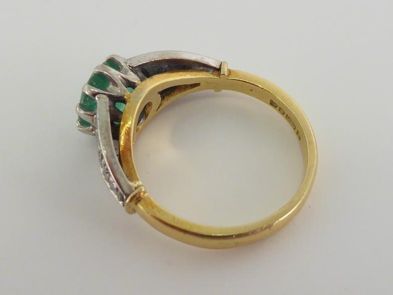 An 18 carat gold, emerald and diamond ring, the central round cut stone 7.2 x 4.5mm, claw set - Image 2 of 4