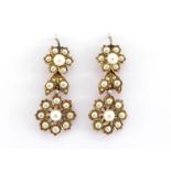 A pair of pearl (untested) earrings, possibly circa 1900, each composed of two daisy clusters